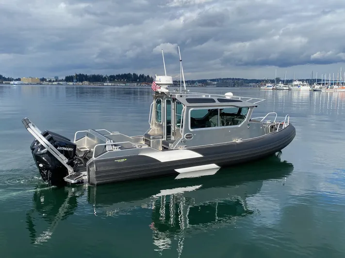  Yacht Photos Pics 2021 Life Proof 25 Full Cabin boat on calm water under cloudy skies.