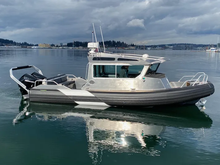  Yacht Photos Pics 2021 Life Proof 25 Full Cabin boat on calm water under cloudy skies.