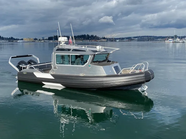  Yacht Photos Pics 2021 Life Proof 25 Full Cabin boat on calm water under cloudy skies.