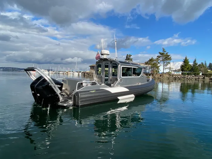  Yacht Photos Pics 2021 Life Proof 25 Full Cabin boat on calm water under a partly cloudy sky.