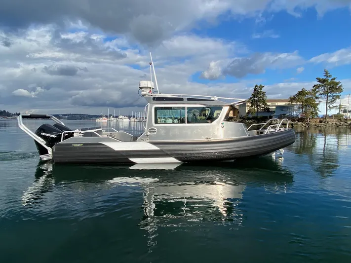  Yacht Photos Pics 2021 Life Proof 25 Full Cabin boat on calm water under cloudy sky.