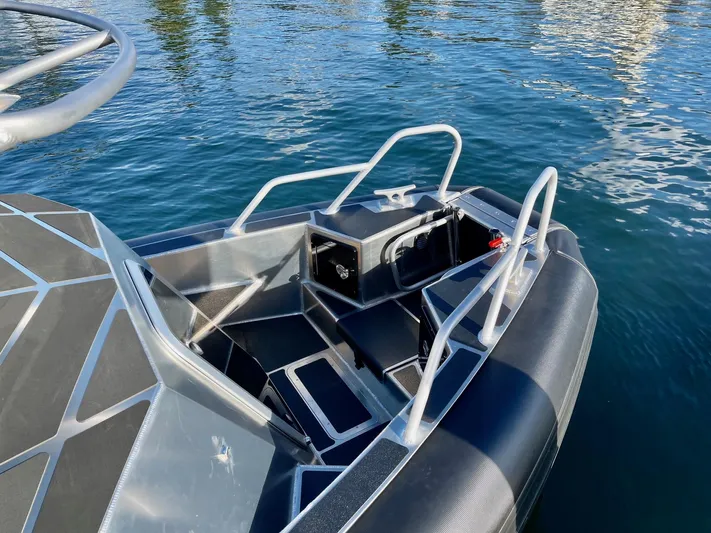  Yacht Photos Pics 2021 Life Proof 25 Full Cabin boat on water, featuring sleek design and sturdy construction.