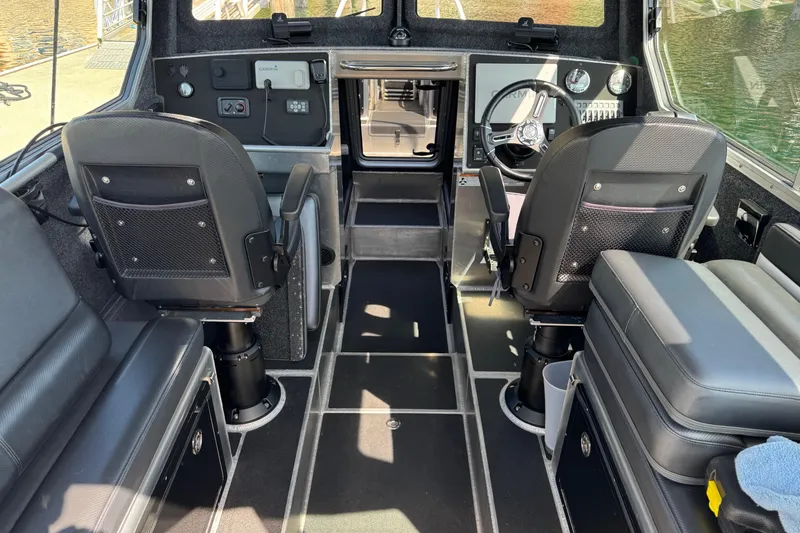  Yacht Photos Pics Interior of 2021 Life Proof 25 Full Cabin boat with modern seating and controls.