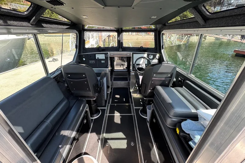  Yacht Photos Pics Interior of 2021 Life Proof 25 Full Cabin boat with seating and steering console.