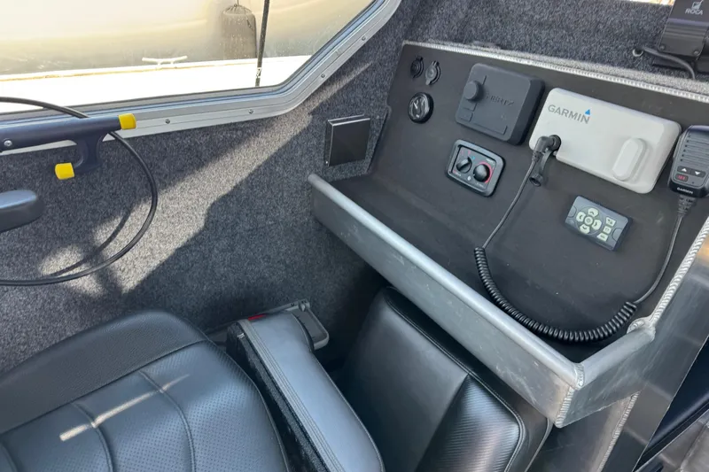  Yacht Photos Pics Interior of 2021 Life Proof 25 Full Cabin boat with control panel and seating.