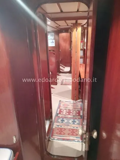  Yacht Photos Pics Interior of 1984 Classic Sciarrelli yacht with wooden finish and patterned rug.