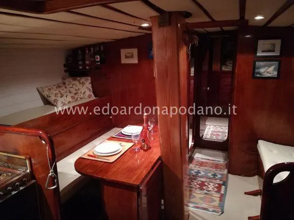  Yacht Photos Pics Cozy 1984 Classic Sciarrelli yacht interior with wooden dining area and nautical decor.