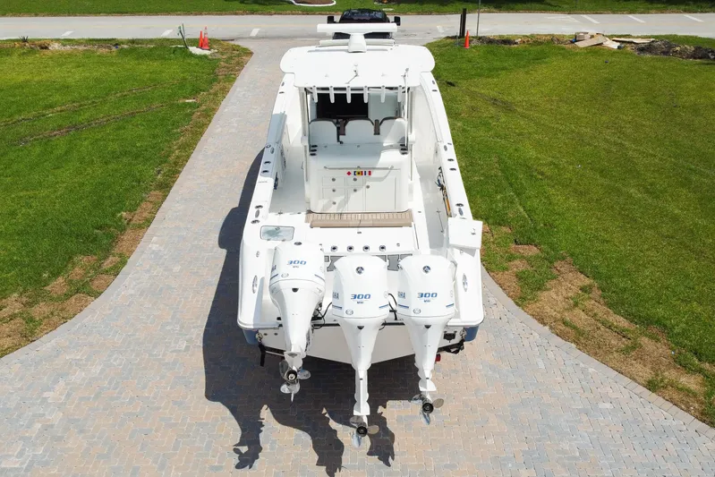  Yacht Photos Pics 2018 Edgewater 370 CC boat with triple Yamaha 300 engines on a paved driveway.