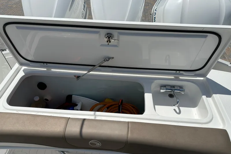  Yacht Photos Pics Open storage compartment on 2018 Edgewater 370 CC boat with faucet and supplies.