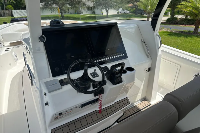  Yacht Photos Pics 2018 Edgewater 370 CC boat helm with modern controls and Garmin navigation system.