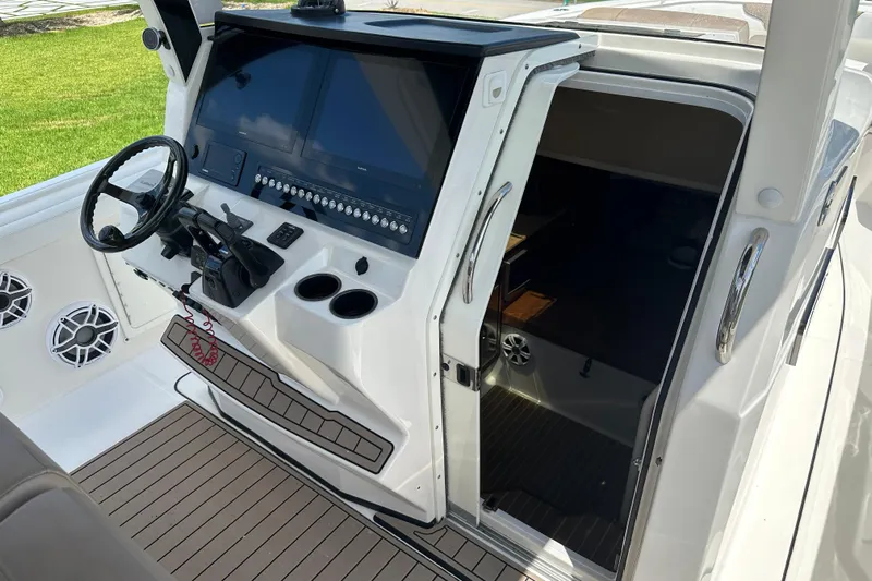  Yacht Photos Pics 2018 Edgewater 370 CC boat cockpit with modern controls and open cabin door.