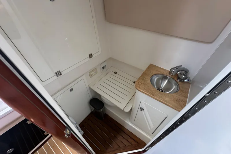  Yacht Photos Pics 2018 Edgewater 370 CC boat interior with compact sink and wooden flooring.