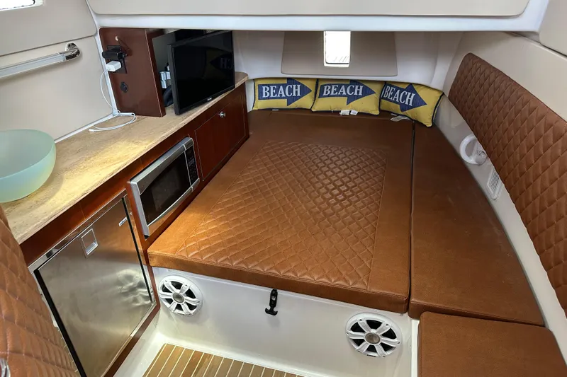  Yacht Photos Pics Interior of 2018 Edgewater 370 CC boat with cozy seating, microwave, and beach-themed pillows.