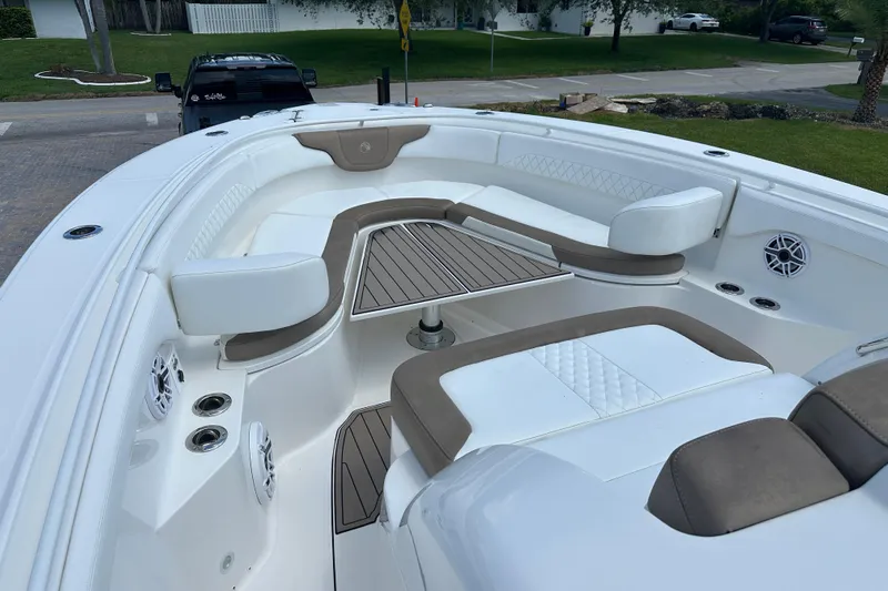  Yacht Photos Pics 2018 Edgewater 370 CC boat interior with cushioned seating and wood accents.