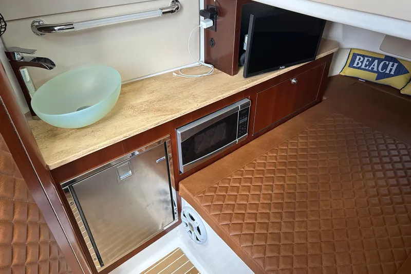  Yacht Photos Pics Luxurious interior of 2018 Edgewater 370 CC boat with kitchenette and seating area.