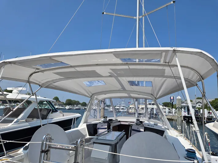 Sabrina Yacht Photos Pics 2013 Beneteau Oceanis 41 sailboat with spacious cockpit and canopy, docked at marina.