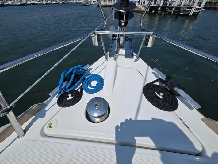 Sabrina Yacht Photos Pics Bow of 2013 Beneteau Oceanis 41 sailboat with ropes and winch, docked at marina.