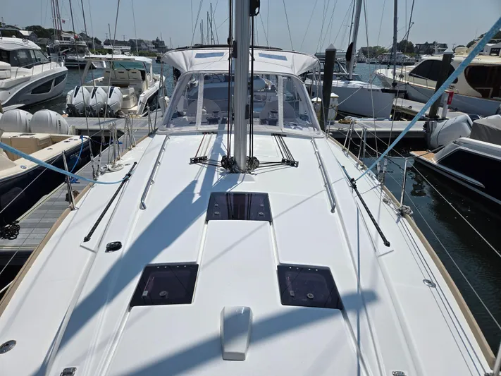 Sabrina Yacht Photos Pics 2013 Beneteau Oceanis 41 sailboat docked in a marina, showcasing its sleek deck design.
