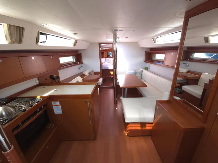 Sabrina Yacht Photos Pics Interior of 2013 Beneteau Oceanis 41 yacht with modern kitchen and seating area.