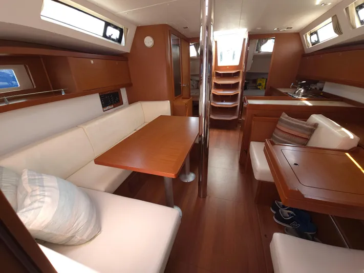 Sabrina Yacht Photos Pics Interior of 2013 Beneteau Oceanis 41 sailboat with wood finish and seating area.