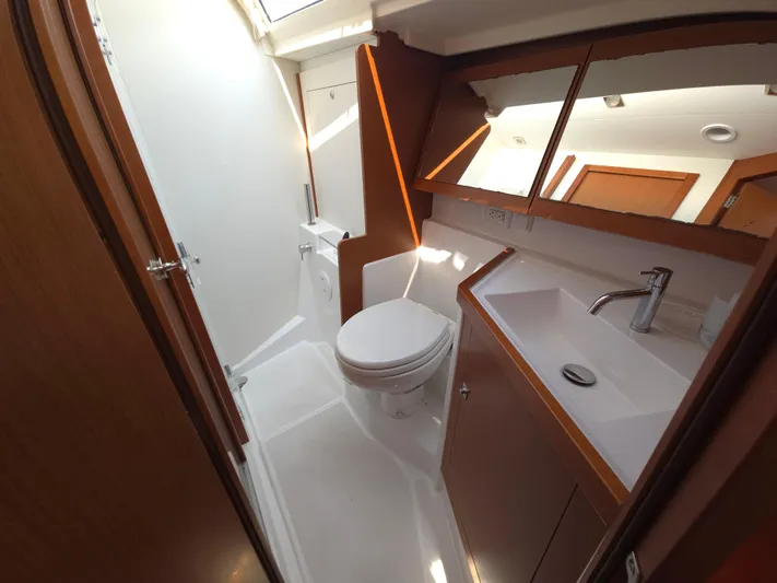 Sabrina Yacht Photos Pics Beneteau Oceanis 41 bathroom, 2013 model, featuring modern fixtures and wooden cabinetry.