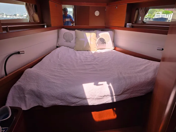 Sabrina Yacht Photos Pics Cozy cabin interior of 2013 Beneteau Oceanis 41 sailboat with a neatly made bed.