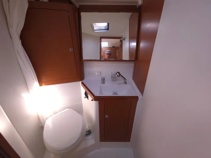 Sabrina Yacht Photos Pics Bathroom interior of 2013 Beneteau Oceanis 41 yacht, featuring sink and toilet.