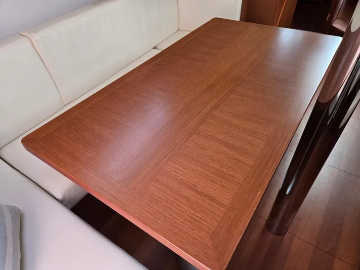 Sabrina Yacht Photos Pics Wooden table in the interior of a 2013 Beneteau Oceanis 41 yacht.