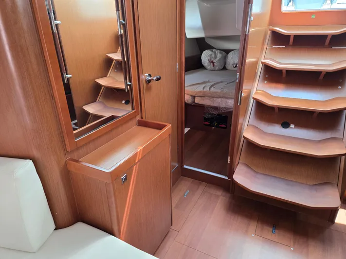 Sabrina Yacht Photos Pics Interior of 2013 Beneteau Oceanis 41 sailboat with wooden cabinetry and cozy sleeping area.