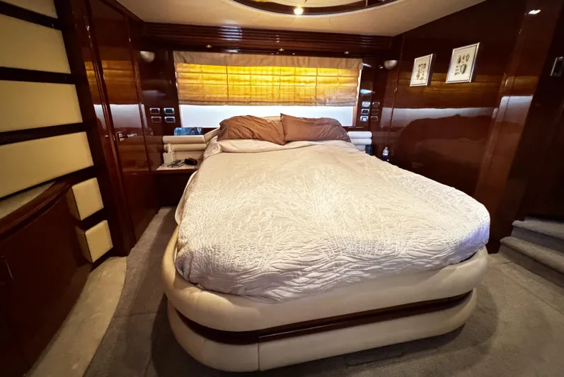Sylvia Yacht Photos Pics Luxurious bedroom interior of 2006 Marquis 65 yacht with elegant wood paneling.