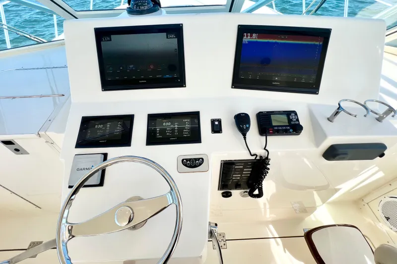 Yeah Buoy Yacht Photos Pics Helm of 2007 Albemarle 41 Express with modern navigation equipment and steering wheel.