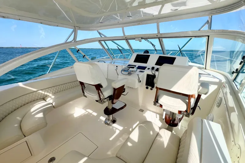 Yeah Buoy Yacht Photos Pics 2007 Albemarle 41 Express yacht interior with helm, white seating, and ocean view.