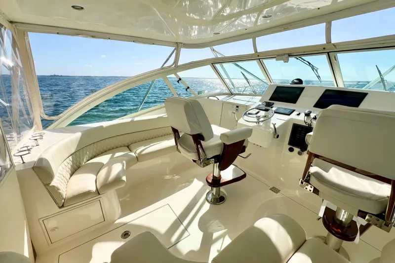 Yeah Buoy Yacht Photos Pics Luxurious 2007 Albemarle 41 Express yacht interior with helm and seating, overlooking the ocean.