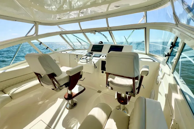Yeah Buoy Yacht Photos Pics 2007 Albemarle 41 Express yacht helm with ocean view, featuring luxurious seating and navigation equipment.