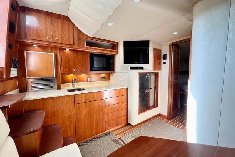 Yeah Buoy Yacht Photos Pics Luxurious 2007 Albemarle 41 Express yacht interior with modern kitchen and wood cabinetry.
