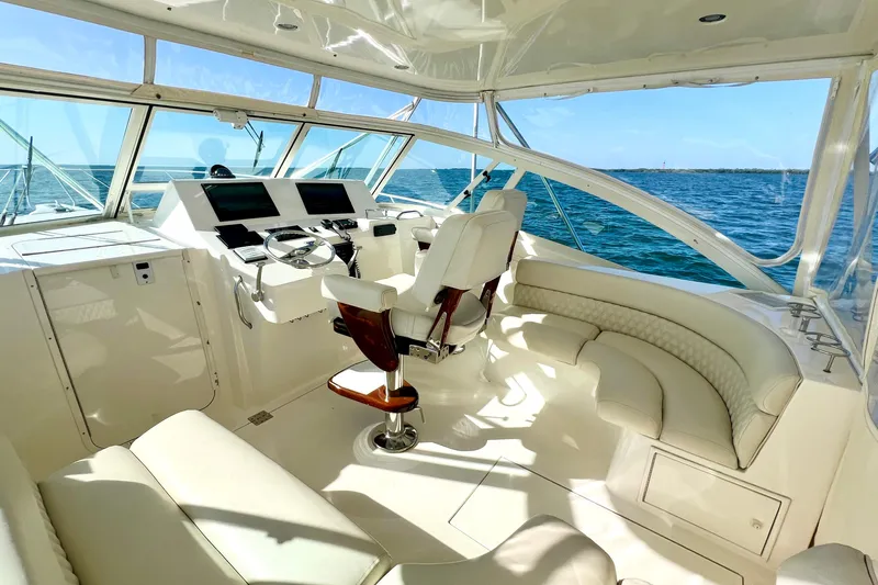 Yeah Buoy Yacht Photos Pics Luxurious 2007 Albemarle 41 Express yacht interior with helm and seating, overlooking the ocean.