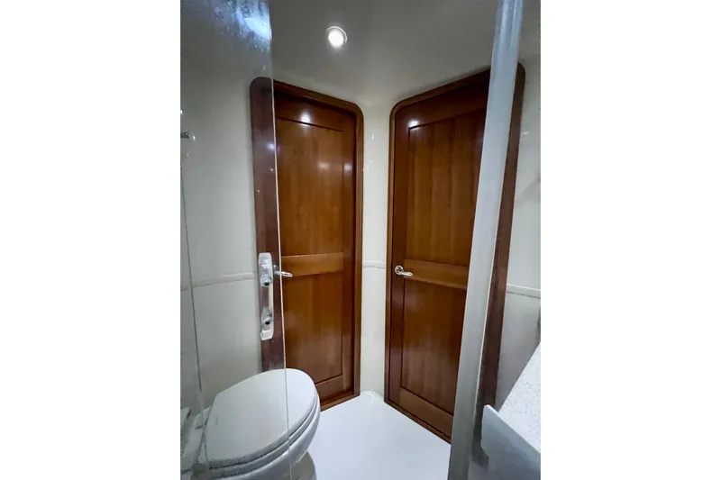 Yeah Buoy Yacht Photos Pics Bathroom interior of 2007 Albemarle 41 Express yacht with wooden doors and modern fixtures.
