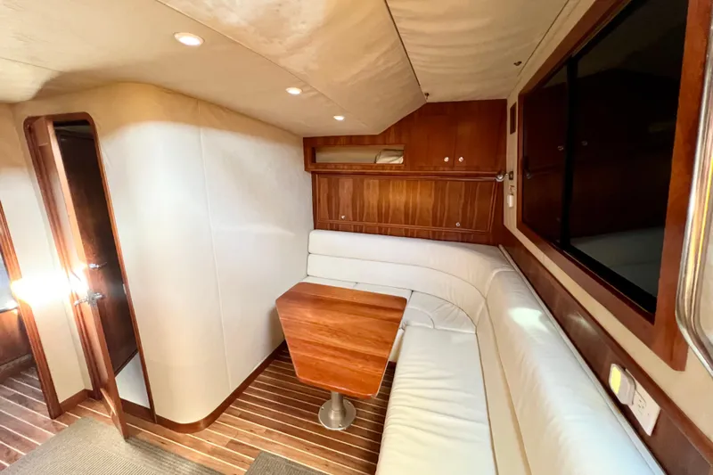Yeah Buoy Yacht Photos Pics Luxurious interior of 2007 Albemarle 41 Express yacht with wood accents and white seating.