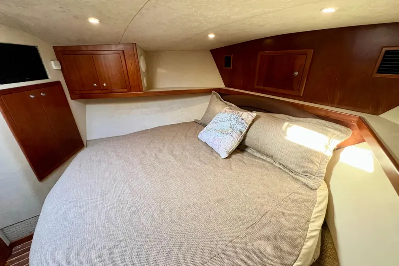 Yeah Buoy Yacht Photos Pics Luxurious cabin interior of 2007 Albemarle 41 Express with cozy bedding and wooden cabinetry.