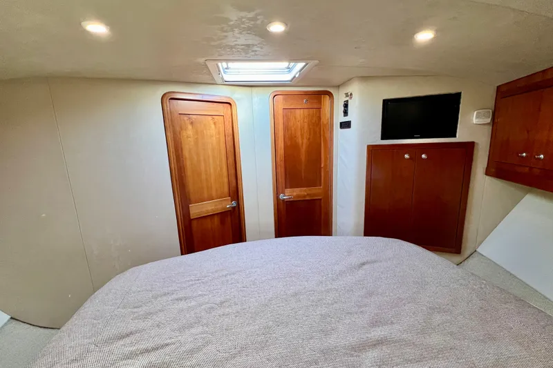 Yeah Buoy Yacht Photos Pics Interior cabin of 2007 Albemarle 41 Express with wooden doors and wall-mounted TV.