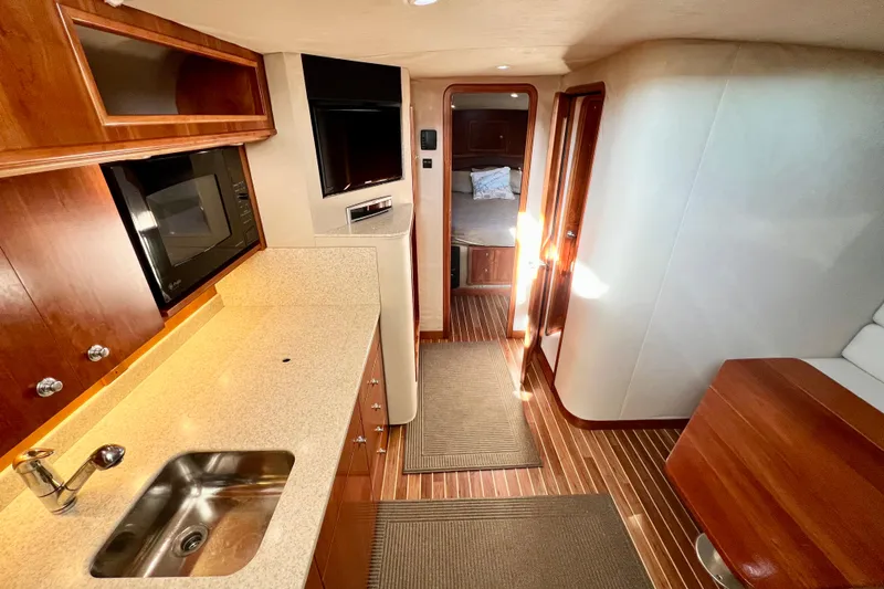 Yeah Buoy Yacht Photos Pics Luxurious 2007 Albemarle 41 Express yacht interior with modern kitchen and cozy cabin.