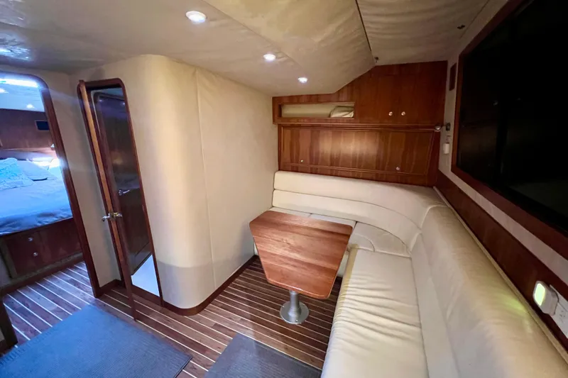 Yeah Buoy Yacht Photos Pics 2007 Albemarle 41 Express yacht interior with wood accents and cozy seating area.
