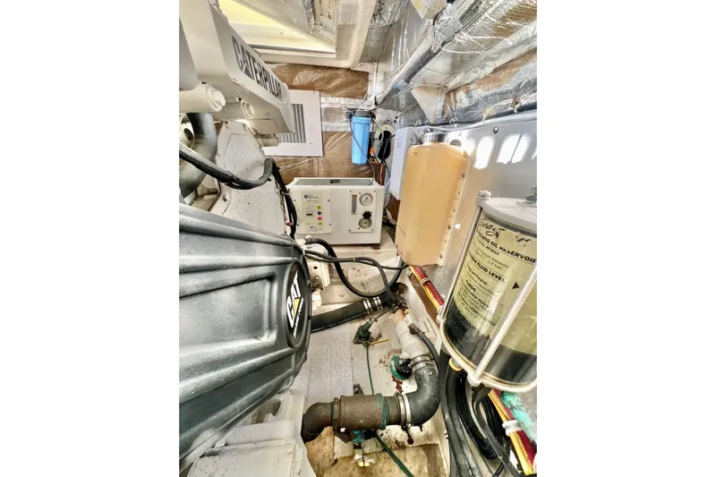 Yeah Buoy Yacht Photos Pics Engine room of 2007 Albemarle 41 Express with Caterpillar components and fluid reservoirs.