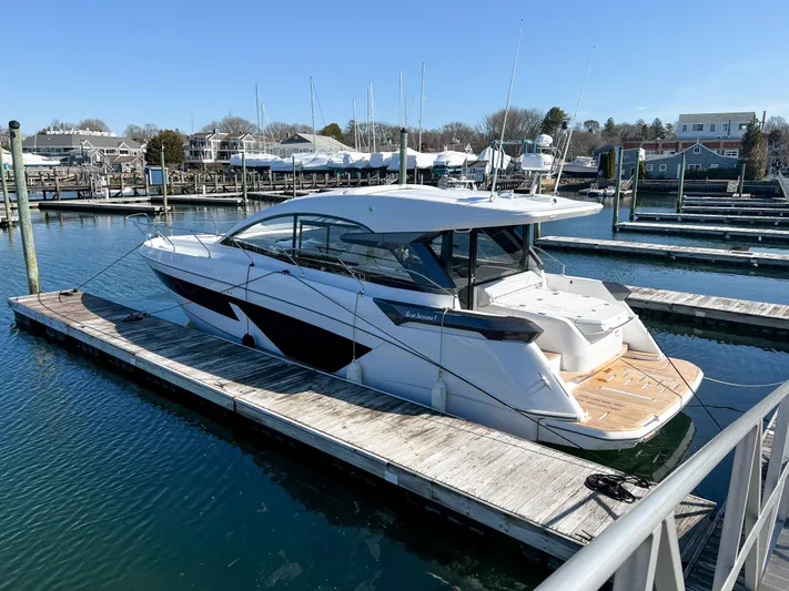 In Stock Yacht Photos Pics 2024 Beneteau Gran Turismo 45 yacht docked in a marina, showcasing sleek design.