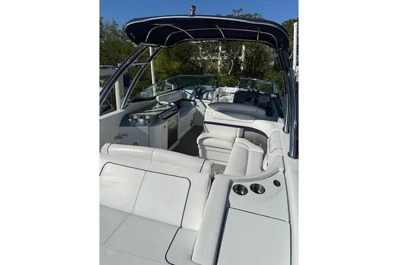  Yacht Photos Pics 2015 Formula 310 Bowrider boat interior with white seating and canopy.