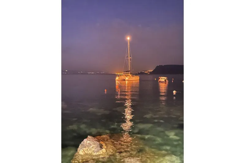 Southern Pearl Yacht Photos Pics Sailboat "Privilege 435" by Groupe Alliura Marine, 2001, illuminated at night on calm water.