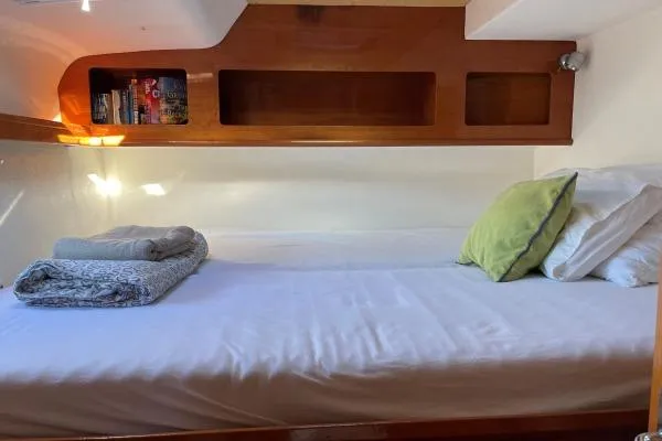 Southern Pearl Yacht Photos Pics Cozy cabin interior of 2001 Groupe Alliura Marine Privilege 435 with bed and wooden shelving.