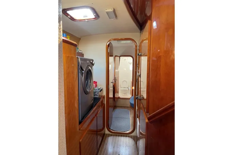 Southern Pearl Yacht Photos Pics Interior of 2001 Privilege 435 yacht with wood finish and laundry area.