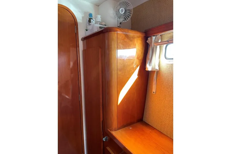 Southern Pearl Yacht Photos Pics Interior of 2001 Privilege 435 yacht with wooden cabinetry and small window.