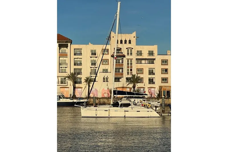 Southern Pearl Yacht Photos Pics Sailing catamaran Privilege 435 by Groupe Alliura Marine, 2001, docked near waterfront buildings.